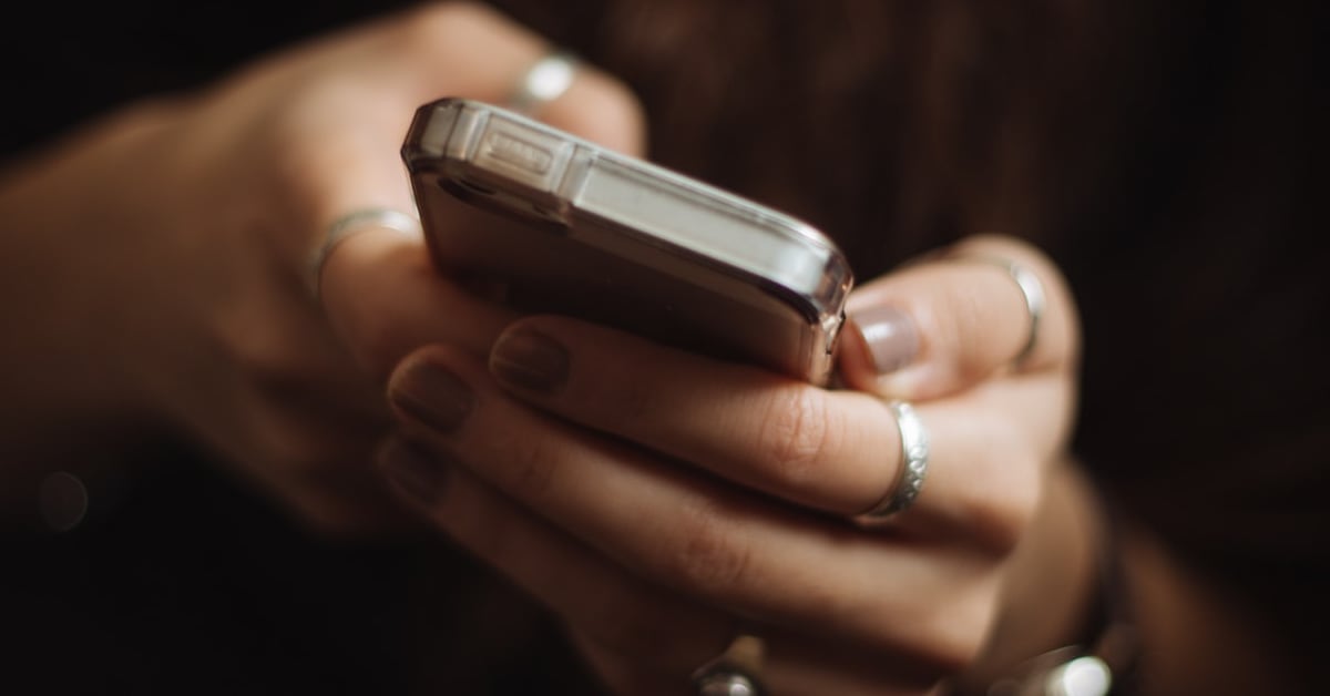 Person using their smartphone.